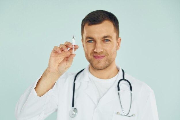 Doctor in uniform standing in the studio