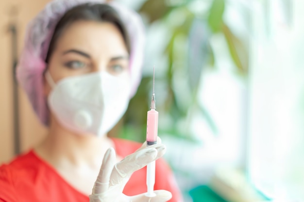 A doctor in uniform with a syringe