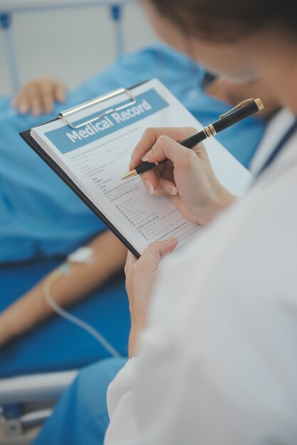 Doctor use stethoscope checking up heart beat lunch of auscultation in doctor office at hospital Patient worker has to get medical checkup every year for her health or medical checkup cardiologist