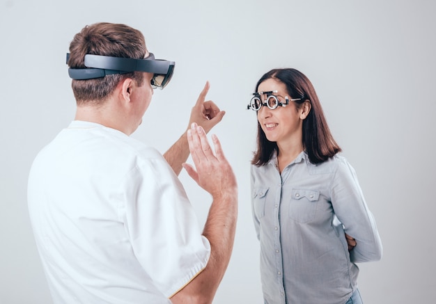 The doctor uses augmented reality glasses in ophthalmology.