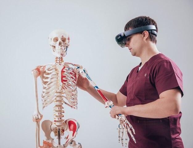 Doctor uses augmented reality goggles to exam human skeleton