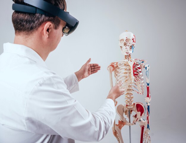 Doctor uses augmented reality goggles to exam human skeleton