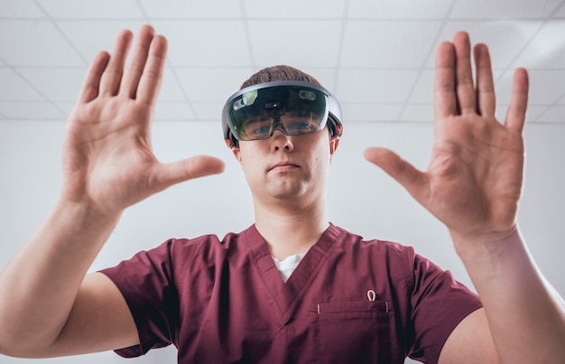 Doctor uses augmented reality goggles.