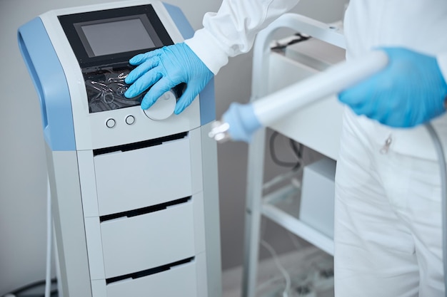 Doctor using BTL machine in clinic office