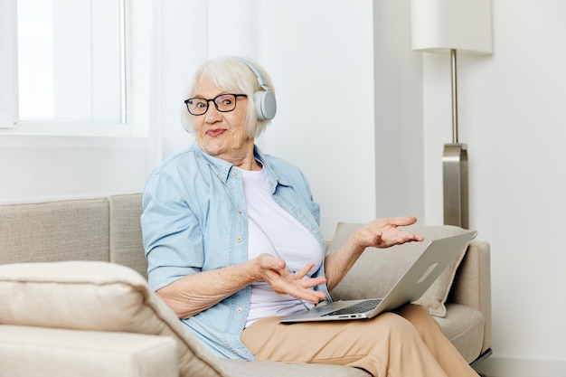doctor using laptop while sitting on sofa at home
