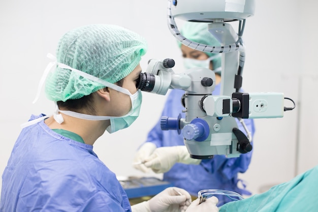 Doctor using microscope for work at operating room