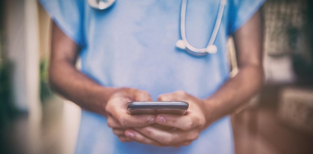 Doctor using mobile phone in hospital