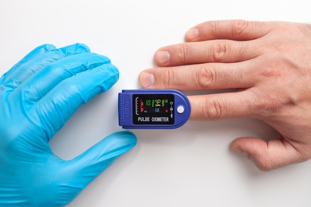 Doctor using pulse oximeter to check patient oxygen saturation