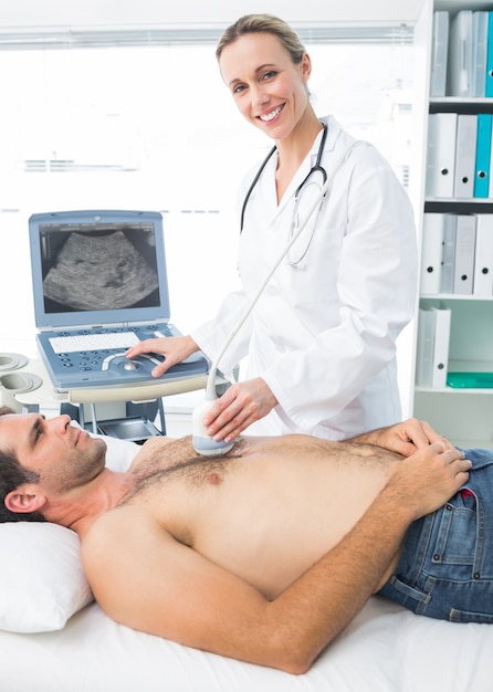 Photo doctor using sonogram on male patient