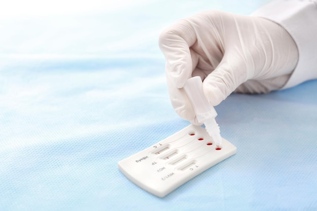 Doctor using test for HIV Hepatitis B C and Syphilis closeup