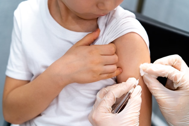 Doctor vaccinating child