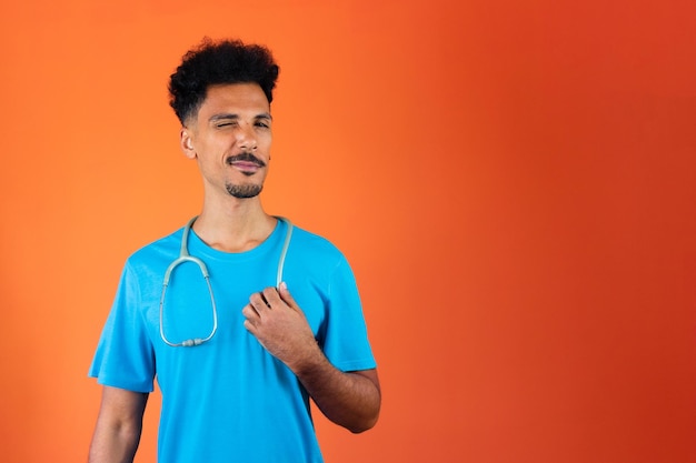 Doctor or Veterinarian Isolated Black Young Doctor Medical Resident With Stethoscope on Orange