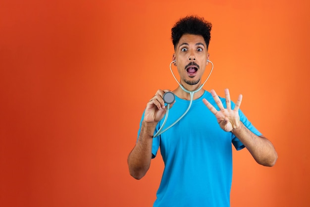 Doctor or Veterinarian Isolated Black Young Doctor Medical Resident With Stethoscope on Orange