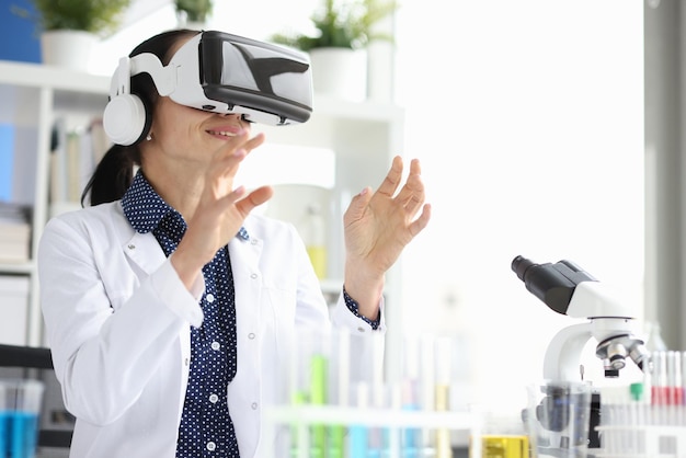 Doctor in virtual glasses in laboratory conducts experiment nanotechnology and medicine of