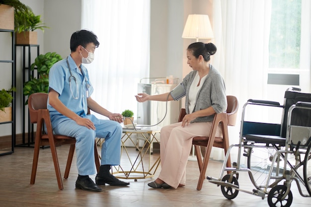 Doctor Visiting Senior Woman at Home