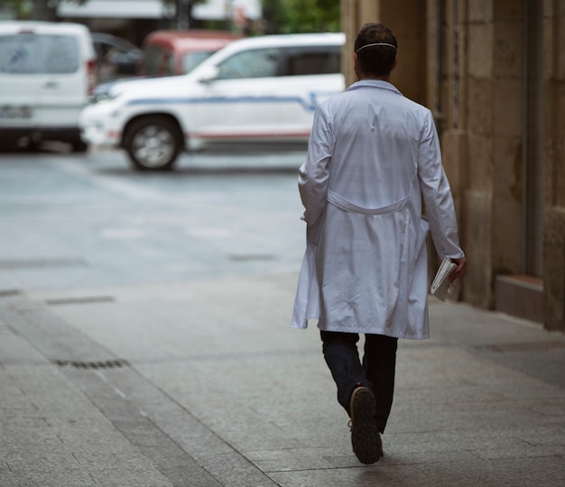 Doctor walking through the city streets