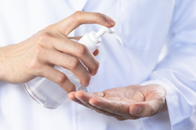 Doctor washing hand by sanitizer gel