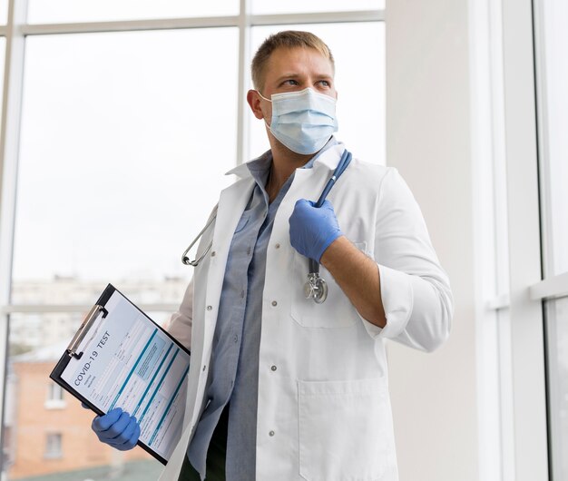 Doctor wearing a face mask and surgical gloves