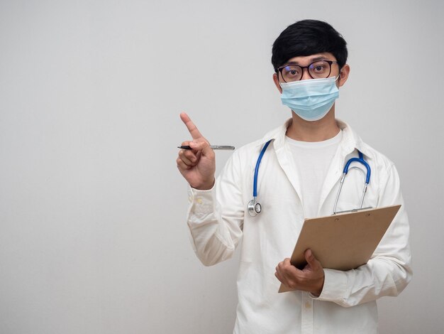 Doctor wearing mask hold check list point finger at copy space