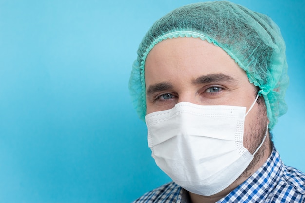 Doctor wearing mask isolated on blue