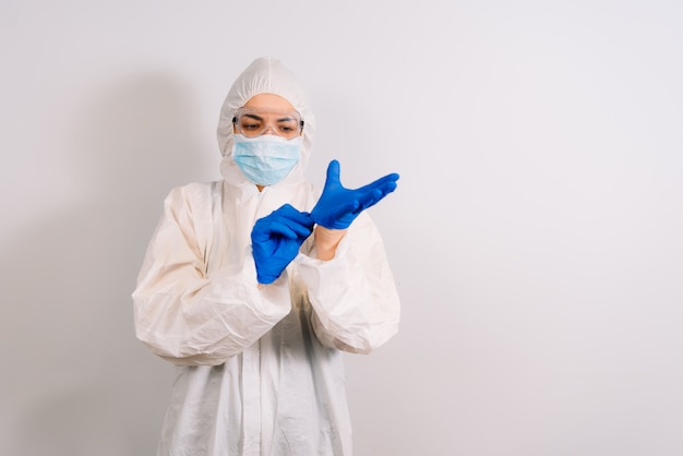 A doctor wearing personal protective equipment including mask, goggle, and suit to protect COVID 19 infection