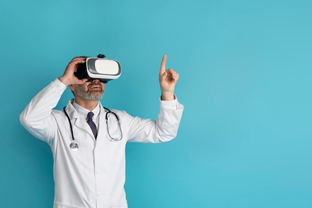 Doctor wearing virtual reality glasses on blue background copy space