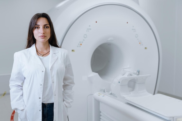 A doctor in a white coat in the diagnostic room at the clinic Professional CT scanner