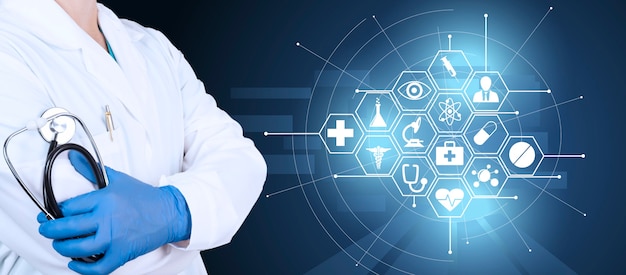 Doctor in a white coat, protective gloves and a stethoscope in his hands against the background of the concept of medical innovation. Health care icons on blue background. High quality photo