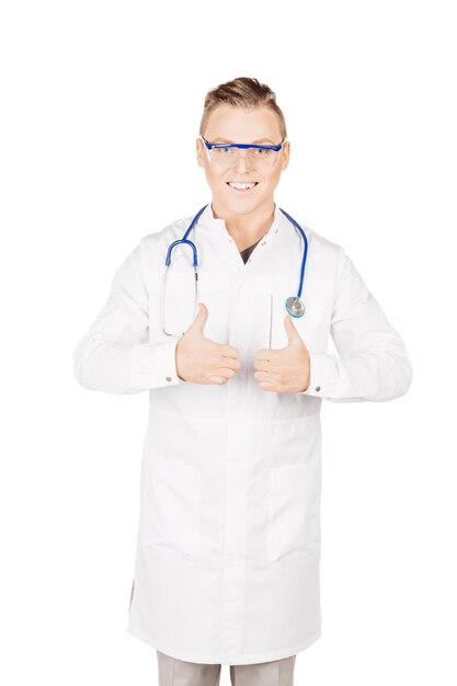 親指を立てるサインを示す聴診器と白衣を着た医師人と薬の概念白い背景で隔離の画像