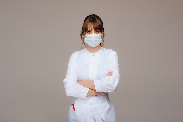 doctor in a white medical coat and mask