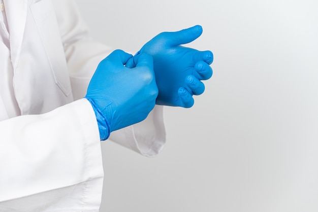 a doctor who takes off his blue latex gloves