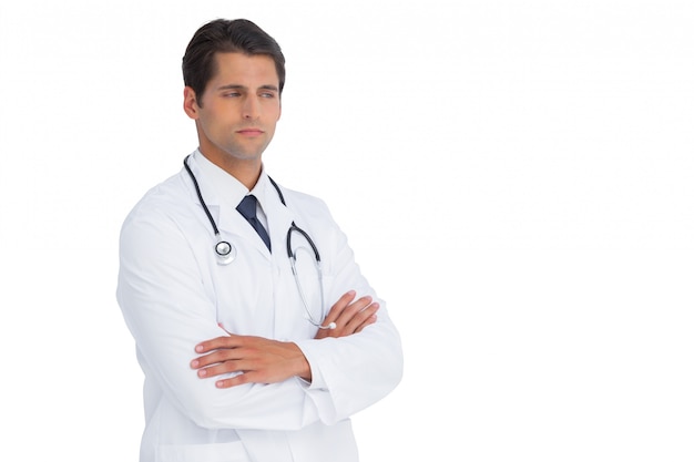Doctor with arms crossed frowning