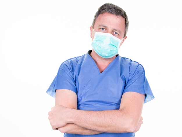 Doctor with arms crossed wearing protective mask