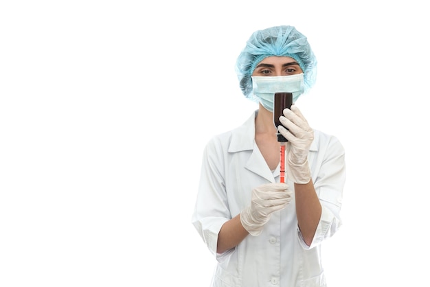 Doctor with bottle and syringe isolated on white wall