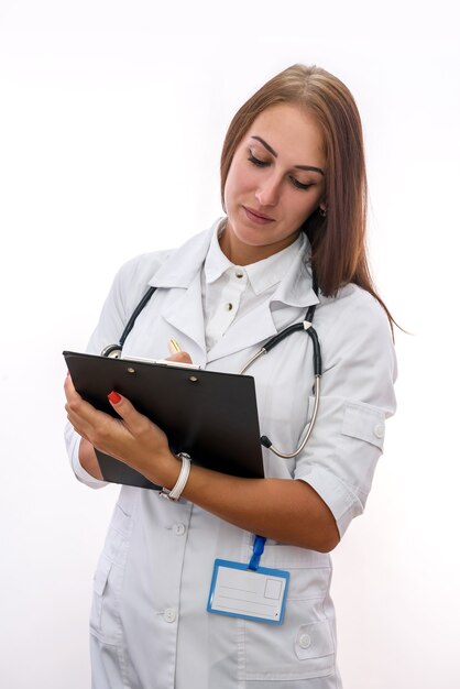 Doctor with clipboard. Pretty woman in medical uniform holding clipboard isolated on white