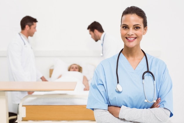 Doctor with colleagues and patient behind