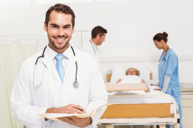 Doctor with colleagues and patient behind