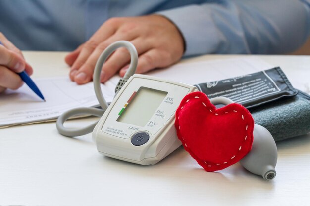 Doctor with digital tonometer and heart