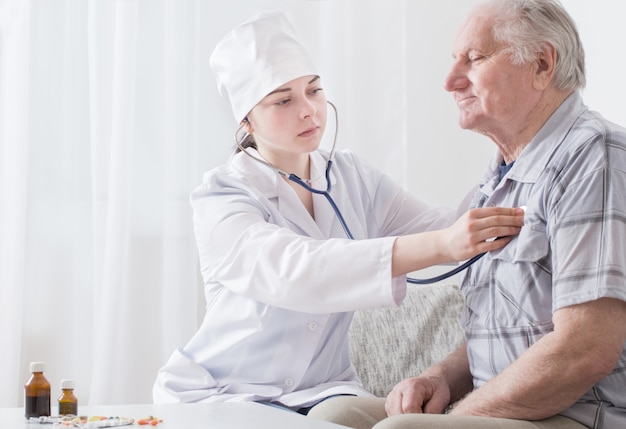 Doctor with elderly men indoor