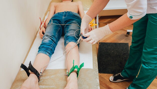 Doctor with electrocardiogram equipment making cardiogram test