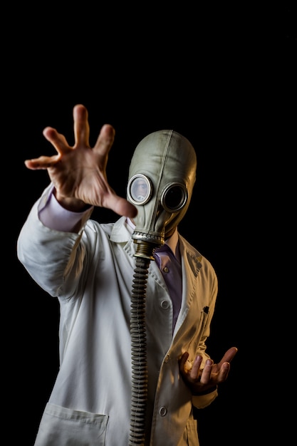 Doctor with gas mask gesturing with hands