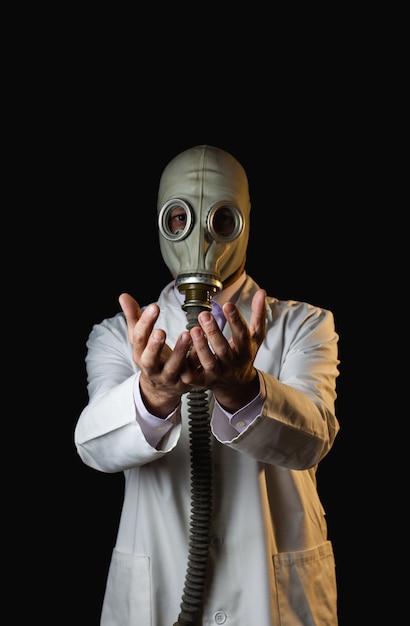 Doctor with gas mask showing his hands