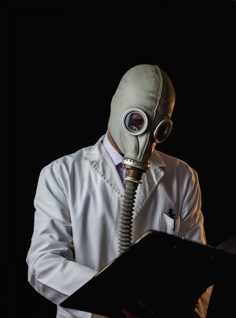 Doctor with gas mask writing a prescription