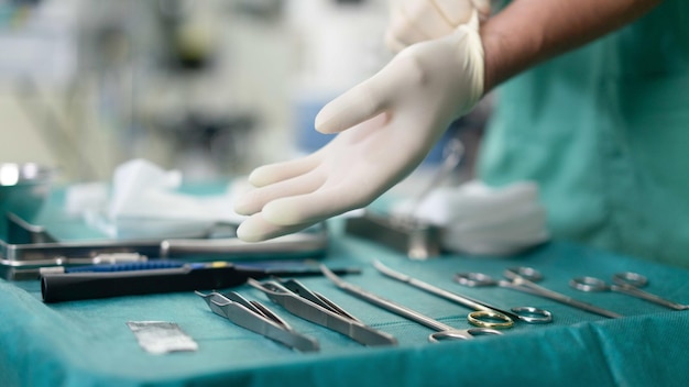 A doctor with gloves using surgical instruments before the surgery starts