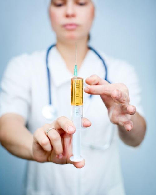 Doctor with huge syringe