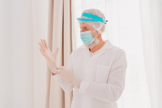 Doctor with mask and face protector is ready to work in hospital