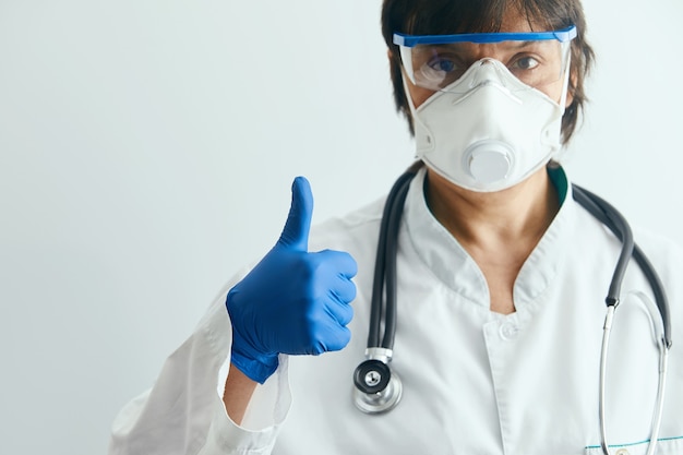 Doctor with medical equipment showing thumbs up