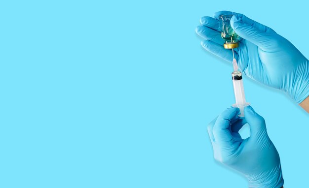 Photo doctor with medical glove with syringe invented vaccines against viruses preparing injections