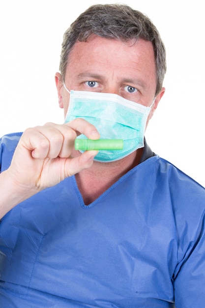 Doctor with medical mask showing test tube