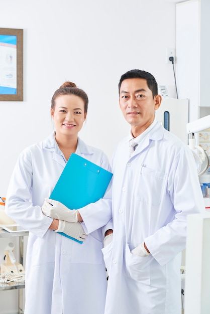 Doctor with nurse standing at office